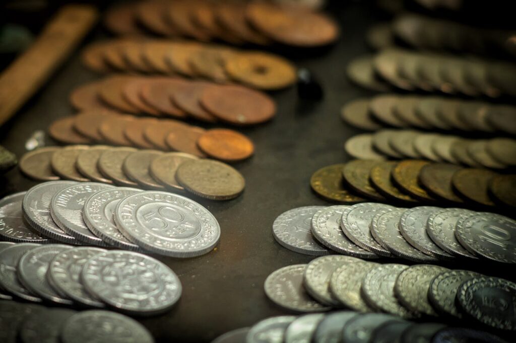 A close-up shot of vintage Indonesian coins displayed on a surface, highlighting various denominations and materials.